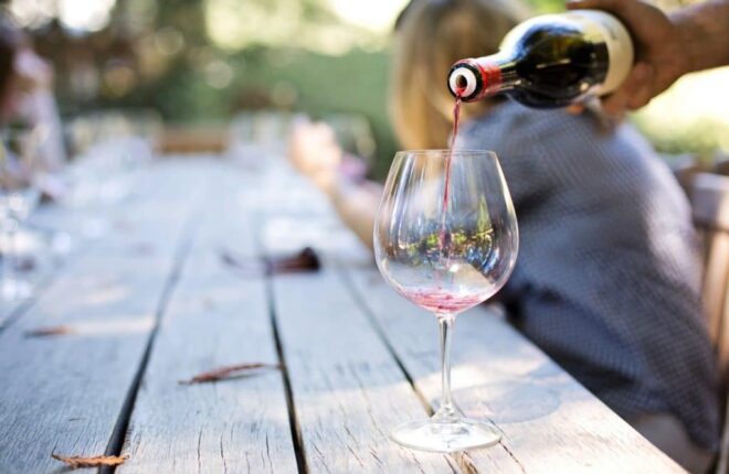 red wine being poured into a wine glass