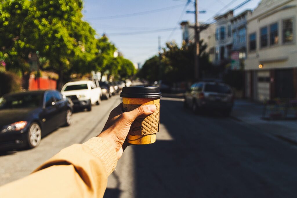Person holding a cup of coffee in San Francisco
