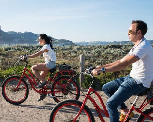 Couple Biking through Golden Gate Park near the Golden Gate Bridge