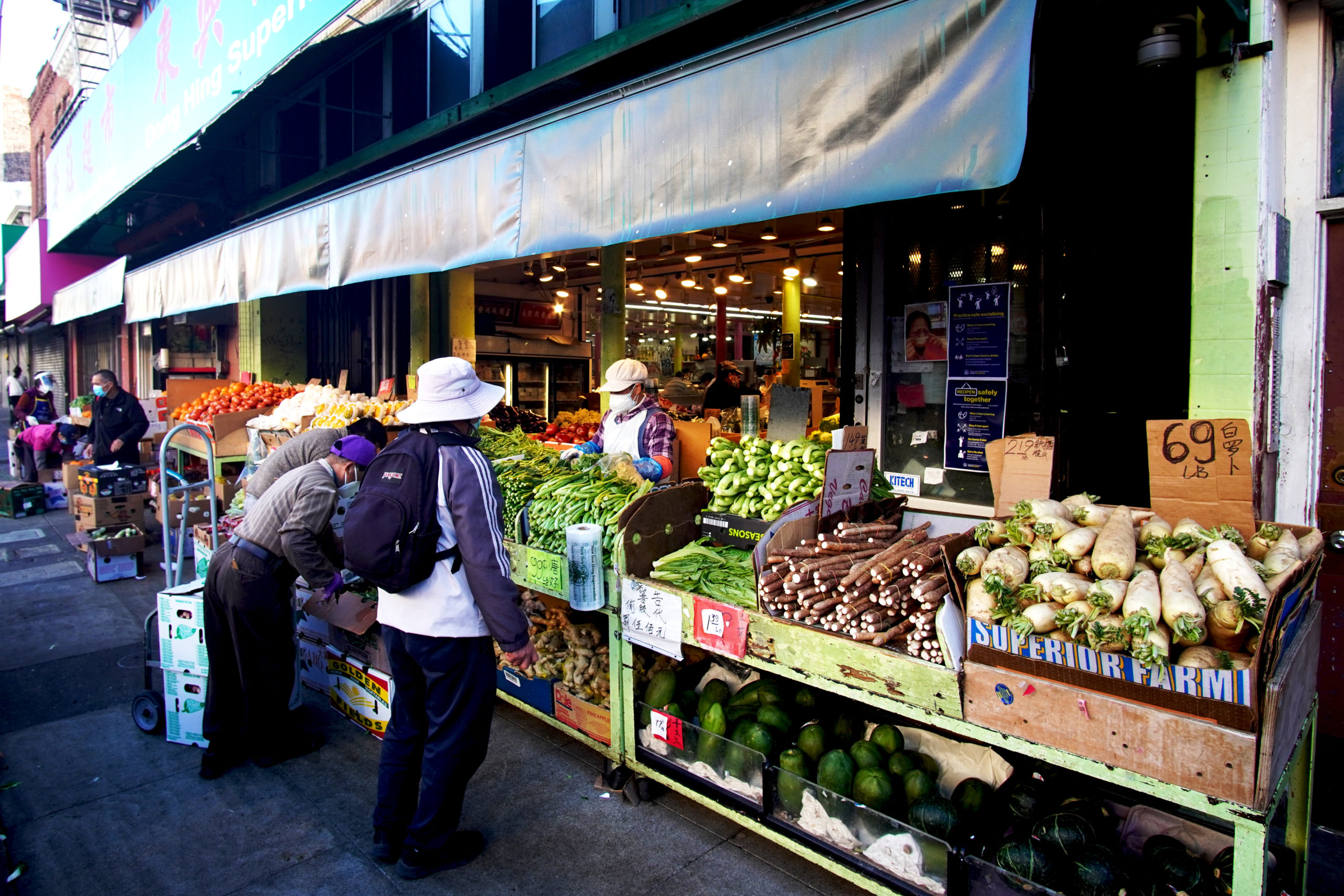 people buying produce at outdoor market