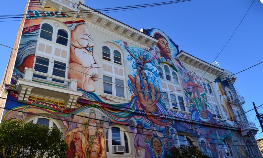 colorful murals of people on the side of a building