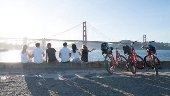 group of bikers looking over the bay and the golden gate bridge