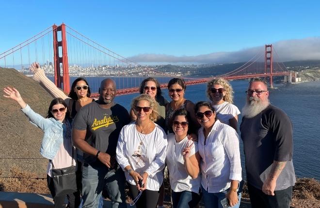 group of coworkers in front of golden gate bridge