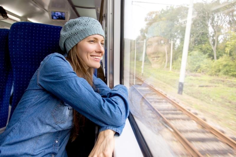woman looking out train window