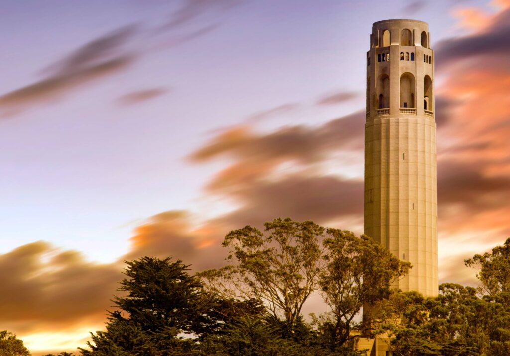 sunset behind closeup of coit tower