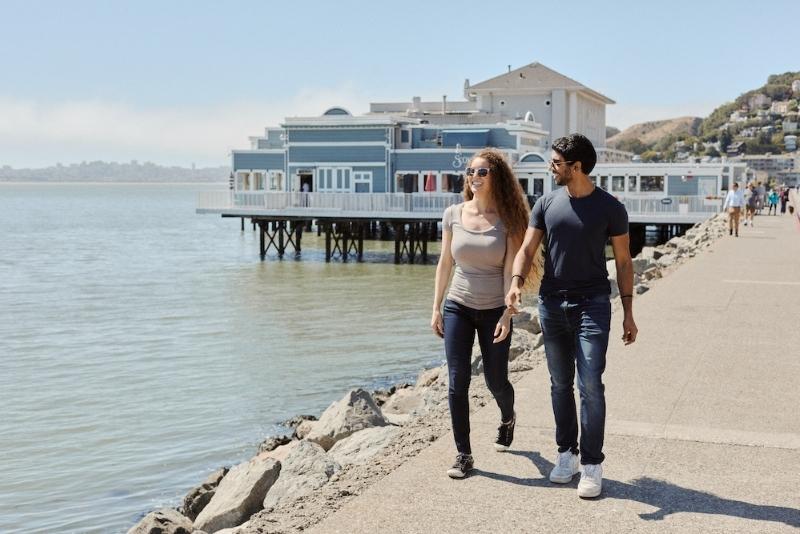 two people walking along the waterfront in sausalito