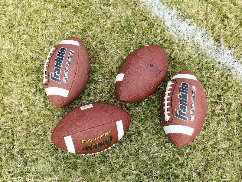 Four Footballs on the Field
