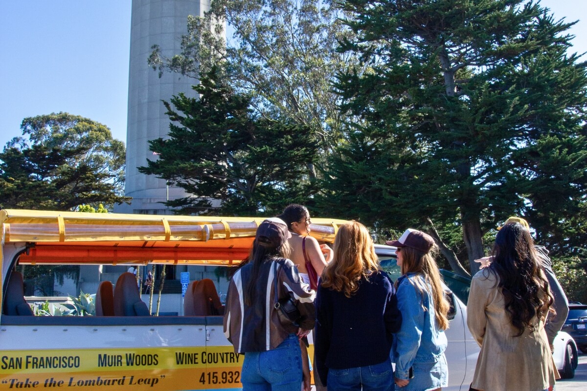 Tour group gathered around Dylan's Tours van near Coit Tower in San Francisco