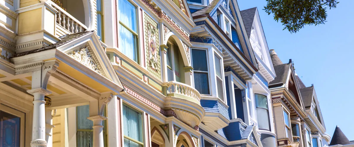 Row of colorful Victorian houses in San Francisco’s Haight-Ashbury neighborhood on a sunny day.