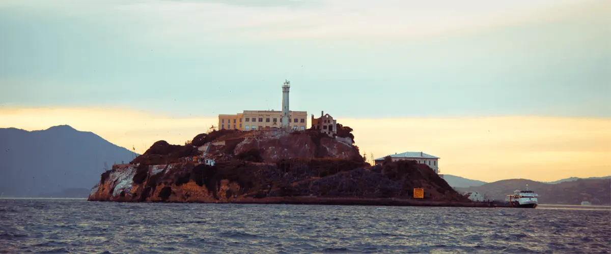 Alcatraz Island at sunset with San Francisco Bay in the foreground