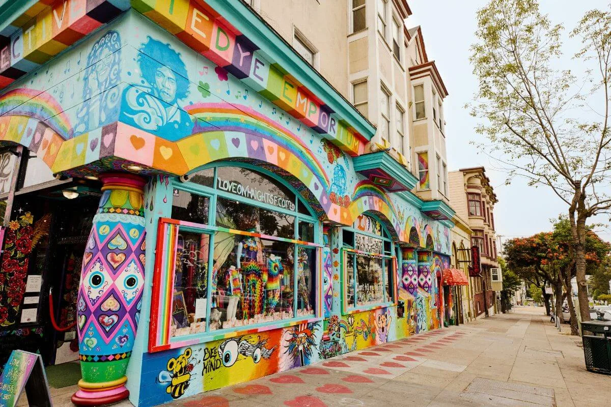 Vibrantly painted boutique facade with rainbows, hearts, and tie-dye displays along Haight Street in San Francisco’s Haight-Ashbury neighborhood.