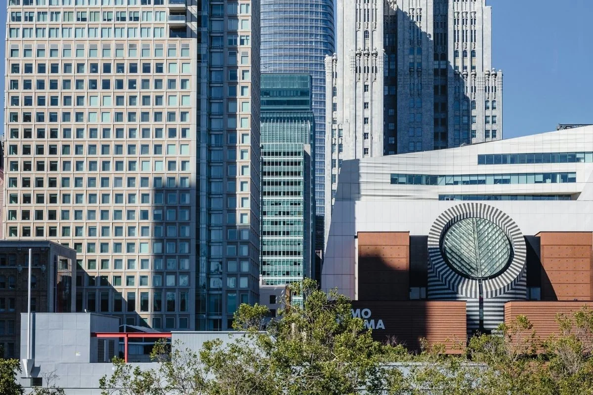 View of the San Francisco Museum of Modern Art (SFMOMA) with surrounding downtown skyscrapers and modern architecture.