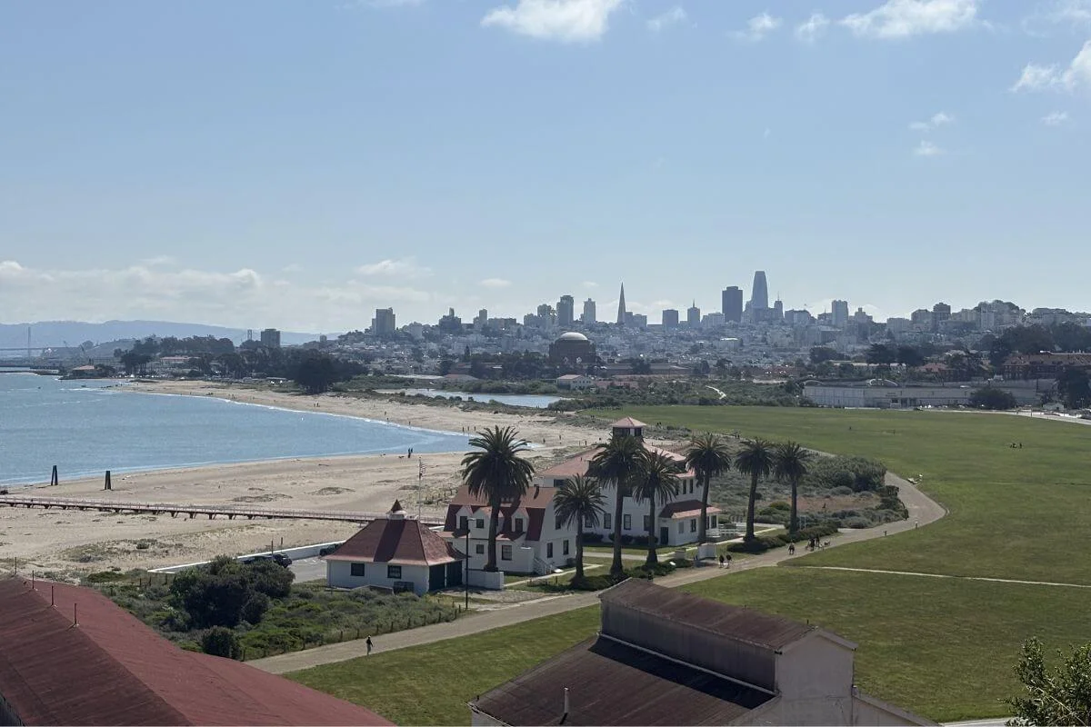 View of Crissy Field's beach and the San Francisco skyline from an elevated point in the Presidio