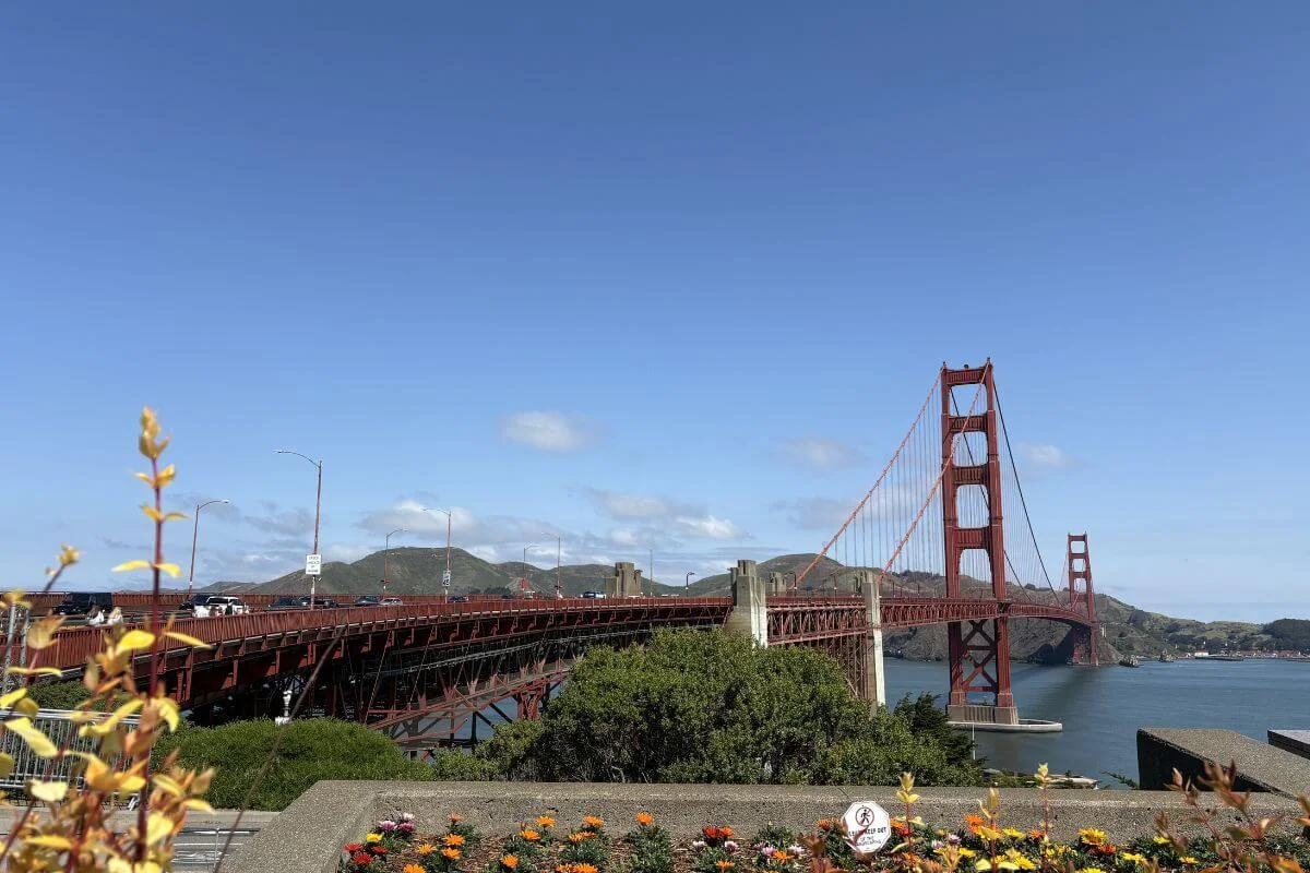 Golden Gate Bridge view from Battery East Vista in the Presidio, with flowering plants in the foreground