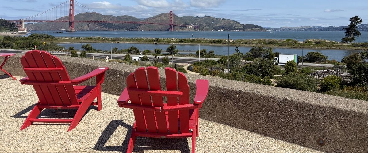 Red Adirondack Chairs with Golden Gate Bridge View at Crissy Field San Francisco Red Adirondack chairs overlooking the Golden Gate Bridge at Presidio Tunnel Tops