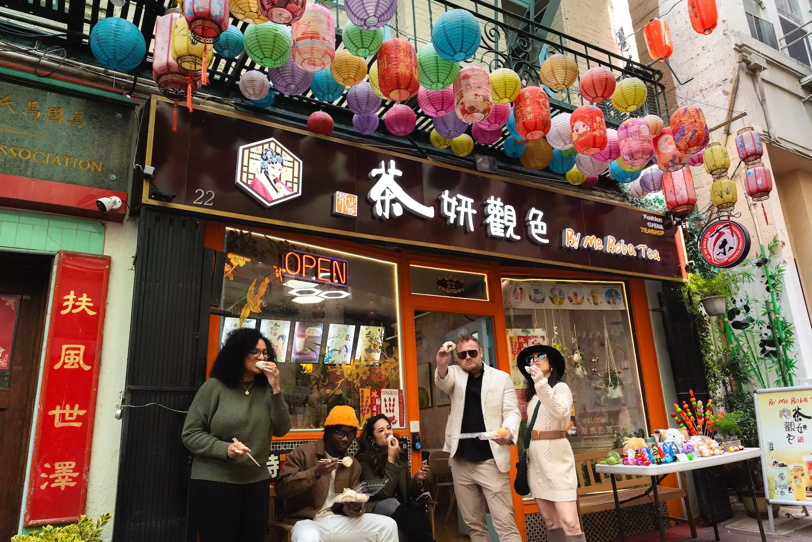 Local Food Experience in San Francisco Chinatown Dylan’s Tours guests enjoying local food beneath colorful lanterns in San Francisco Chinatown