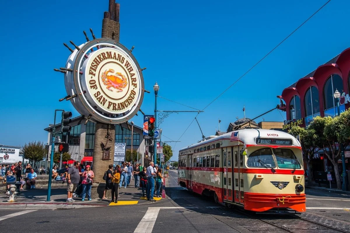 Fishermans Wharf sign with vintage streetcar in San Francisco