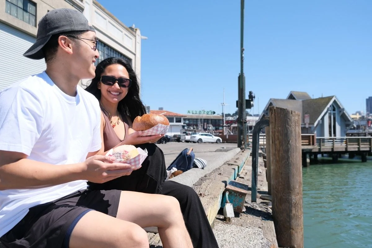 Couple holding sourdough bread bowls at Fisherman's Wharf