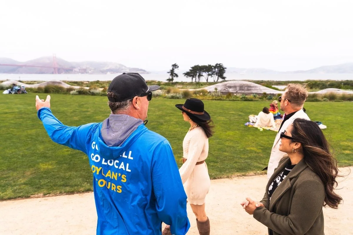 Dylans Tours guide pointing out landmarks to group near Golden Gate Bridge