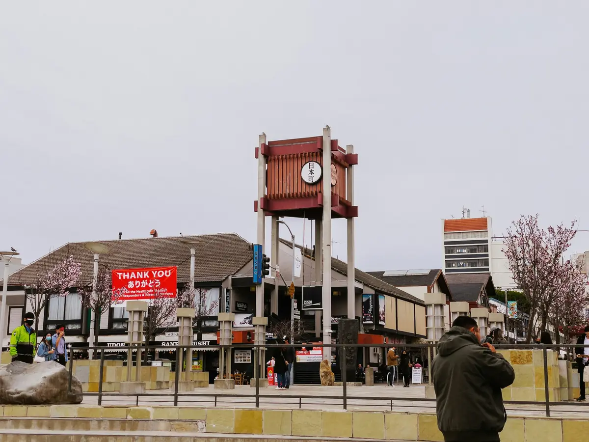Wooden Nihonmachi tower in Japantown’s Peace Plaza, surrounded by restaurants and blossoming cherry trees