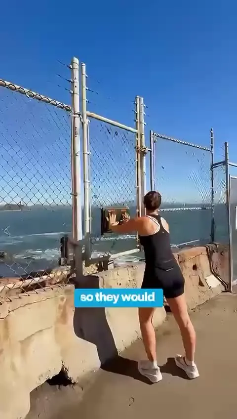 Runner touching Hopper's Hands at Fort Point before heading back along the waterfront